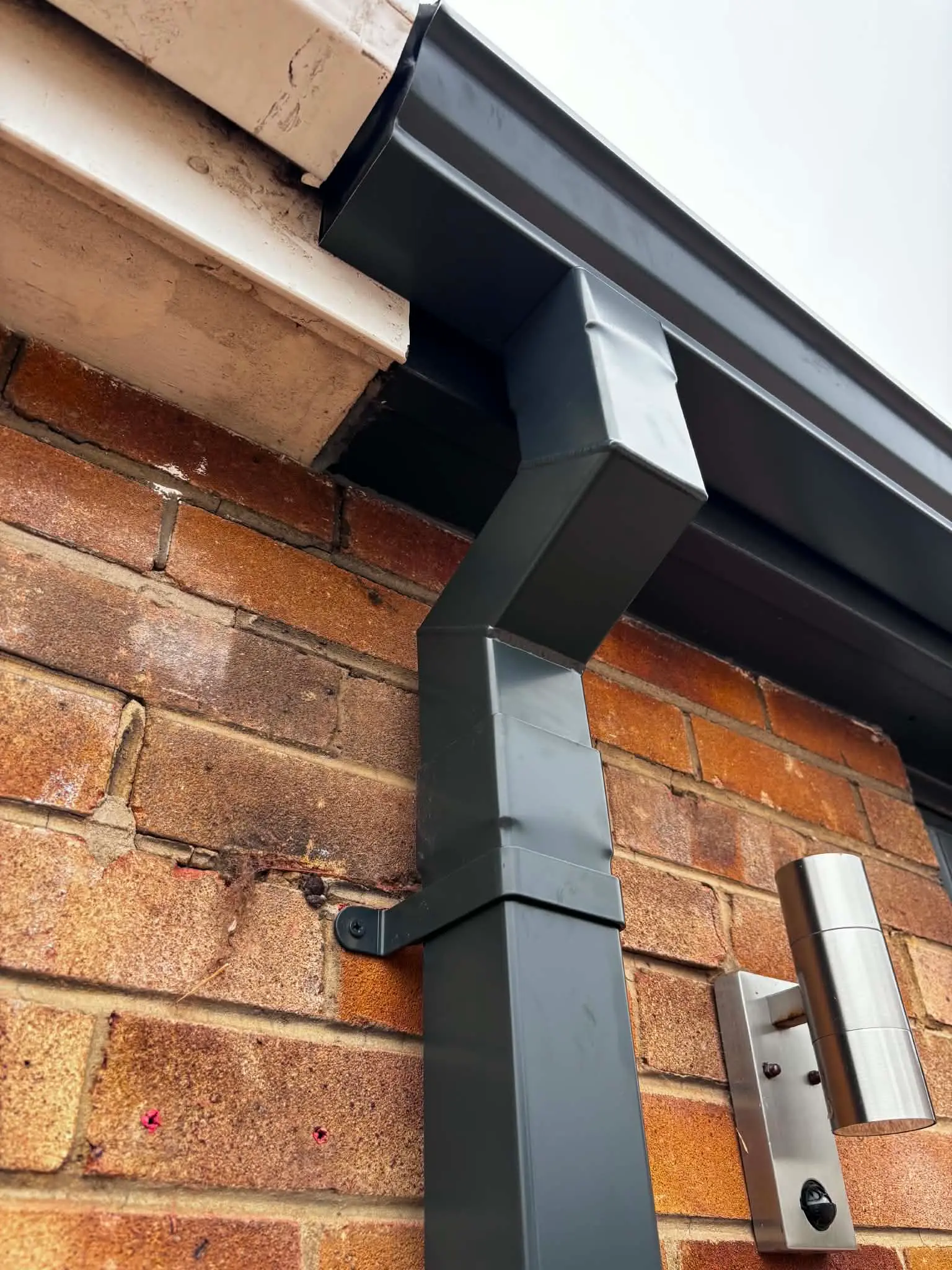 Black downpipe installed neatly against a Yorkshire property