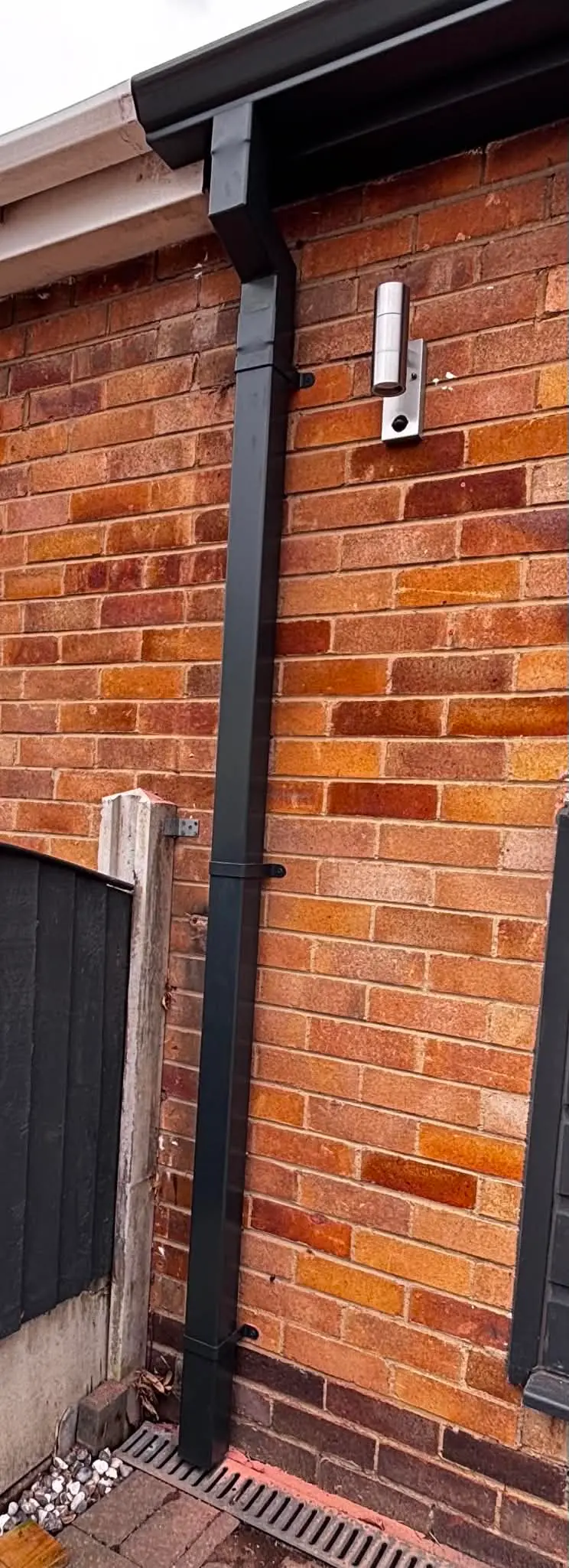 Close-up of gutter outlet and downpipe connection