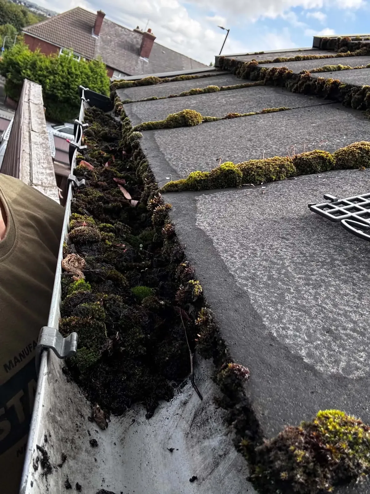 Gutter heavily blocked with moss and debris before clearance in Yorkshire