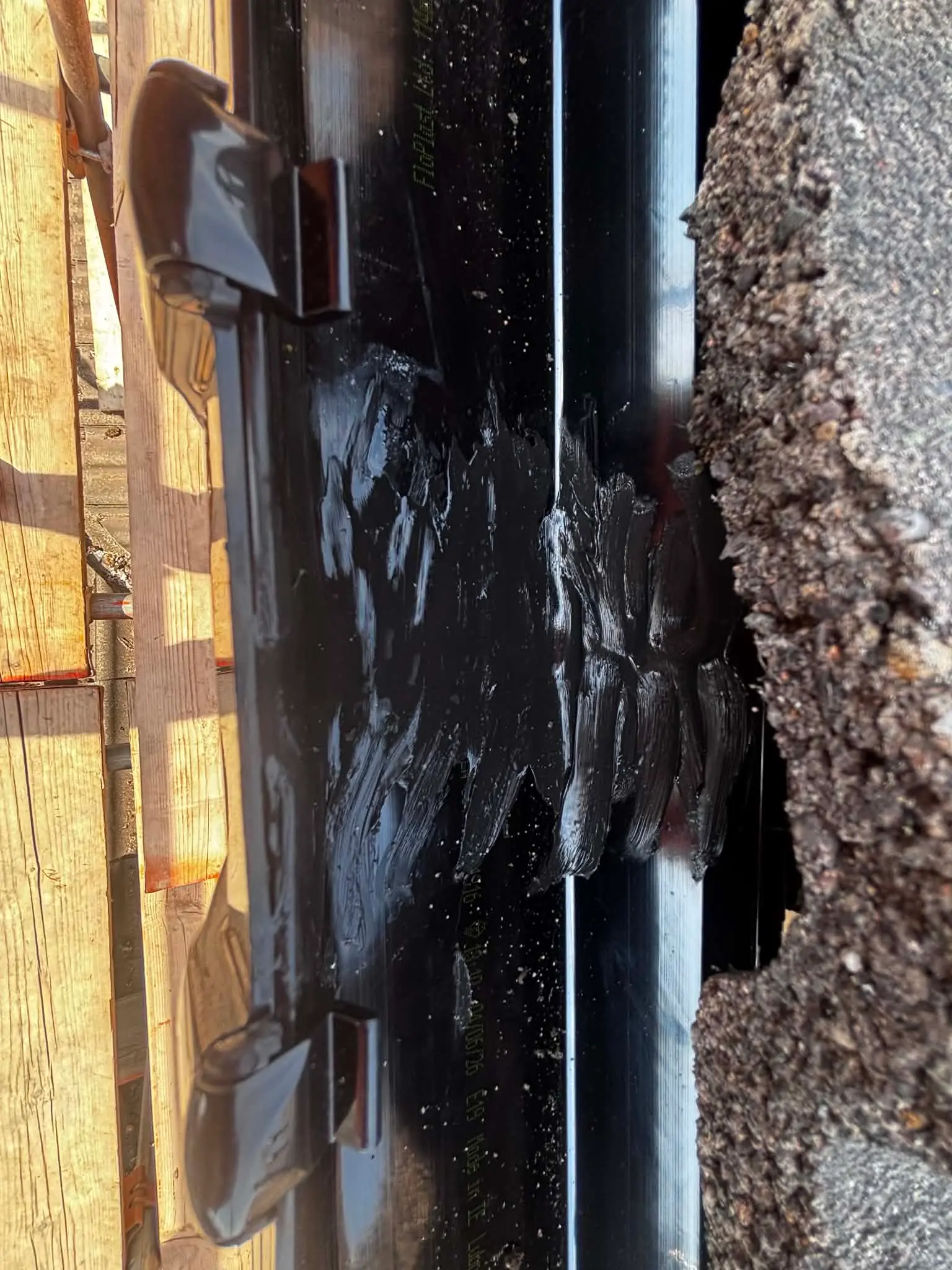 Blocked gutter containing debris before repair
