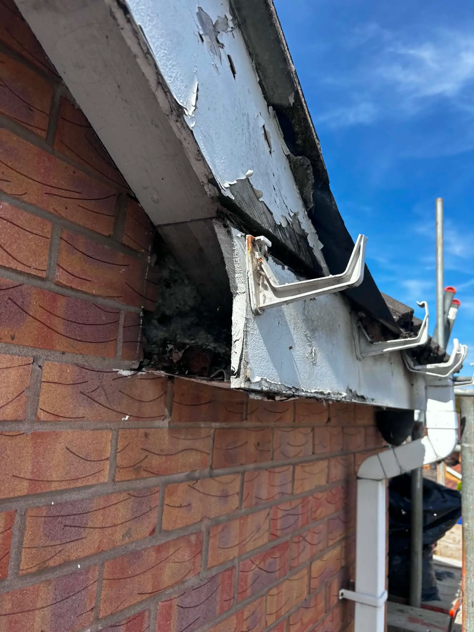 Weathered fascia and gutter corner before renewal