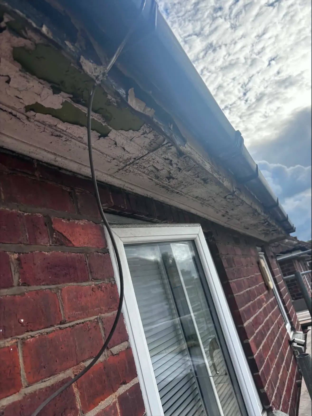 Deteriorated fascia and soffit before replacement