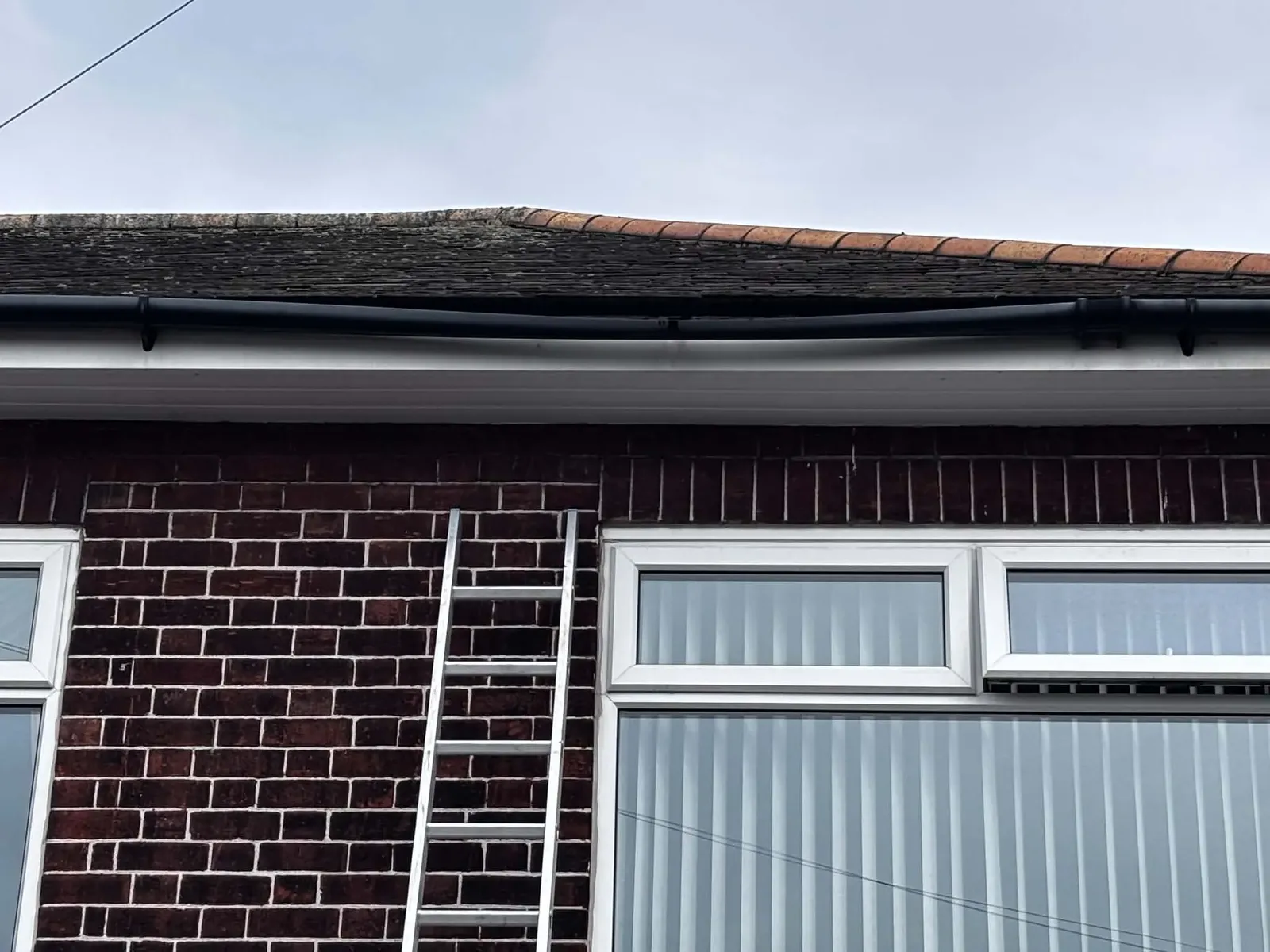Close-up of gutter joint being repaired