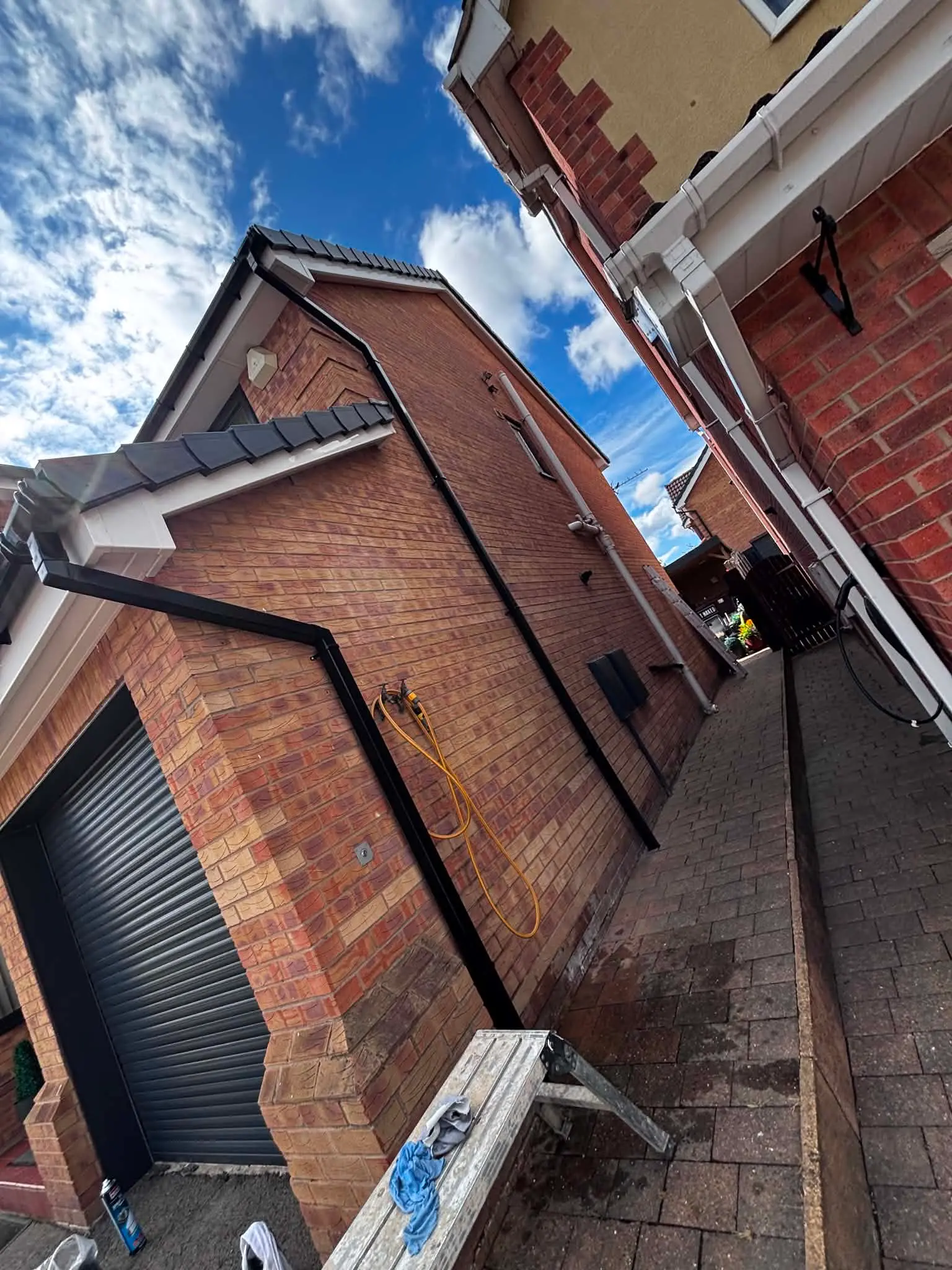 Side elevation after black seamless aluminium guttering installation